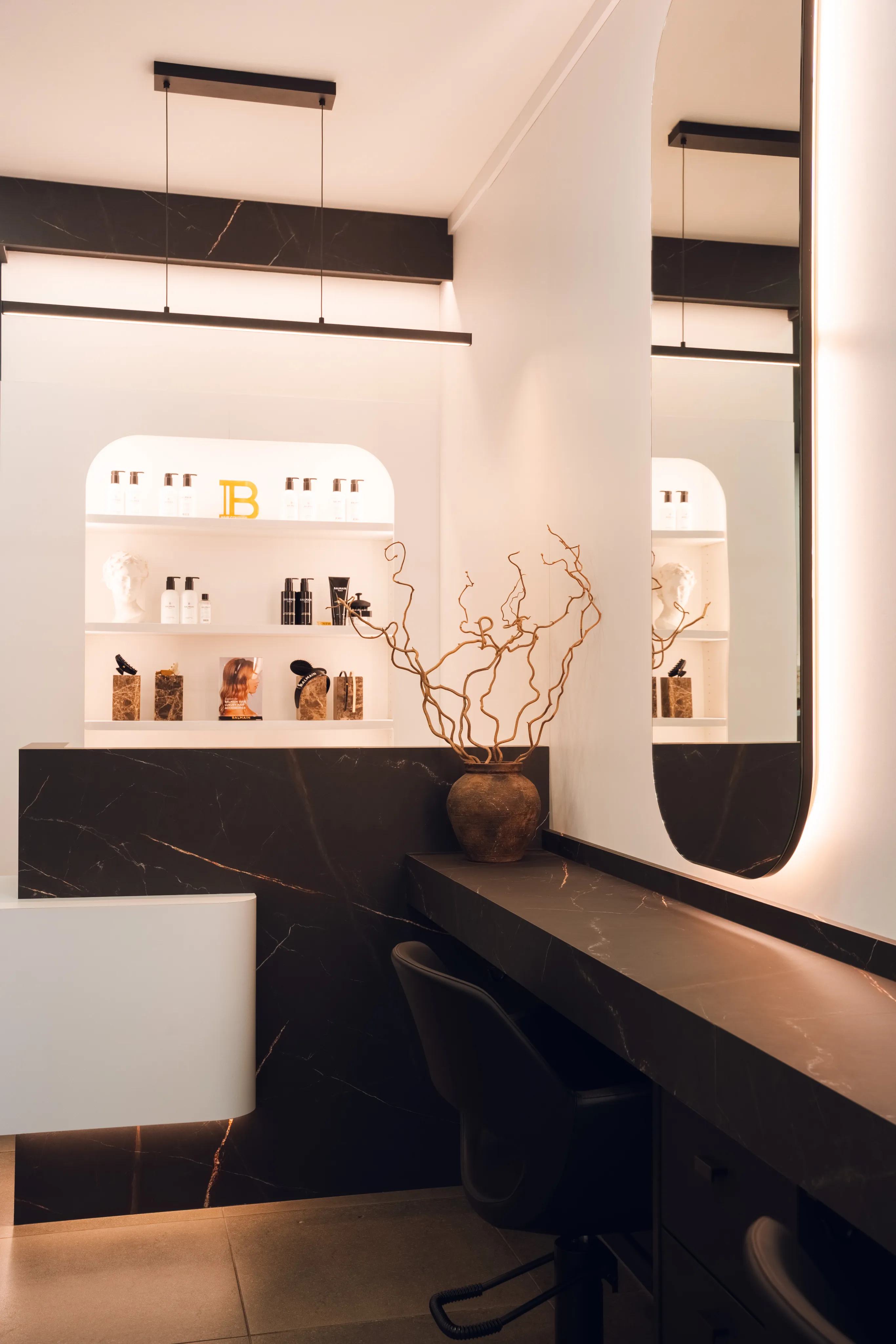 Interior of the Maison Raphaelis salon reflected in a round mirror