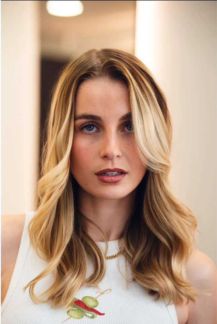 Stylist crafting a braided updo on a client